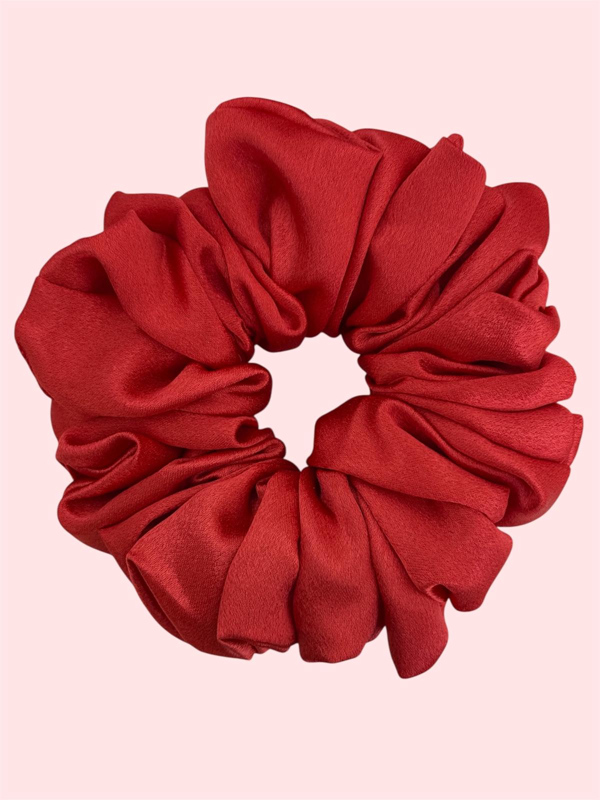 Red scrunchie on a pink background.Scarlet red extra large satin scrunchie XL handcrafted UK